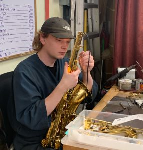 Alex-at-bench Photo of Alex working on a sax